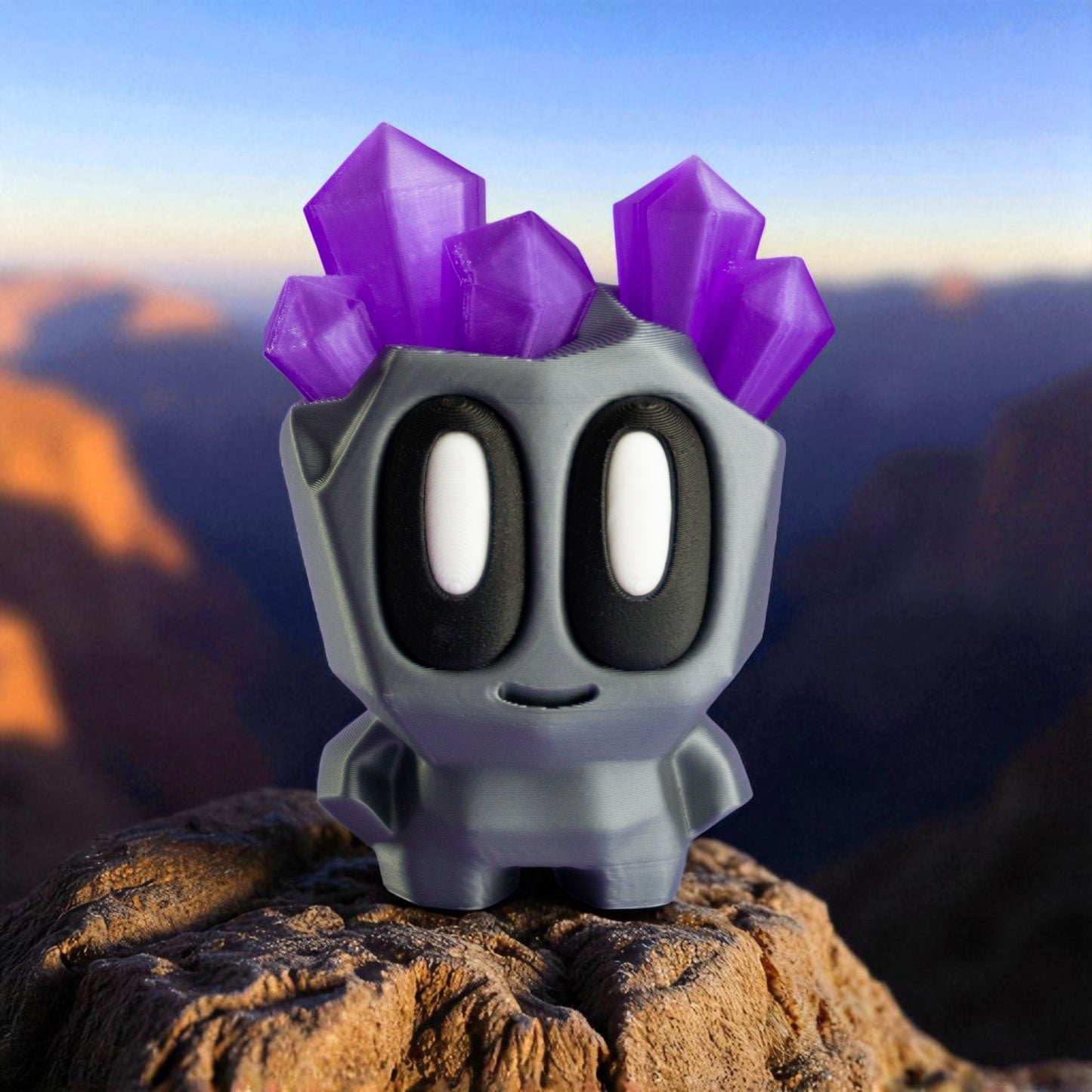 Toy figure with purple spikes on a rock with a mountainous background