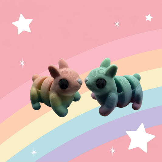 Meet Thistle – a rainbow-colored, 3D printed articulated bunny from Whimsizoo. A playful fidget friend perfect for kids, collectors, and bunny fans!