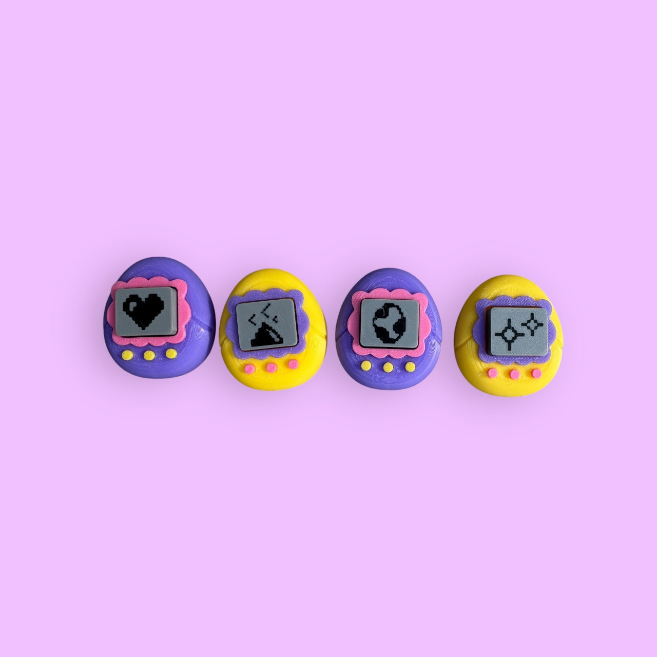 Four colorful toy devices with digital displays on a pink background