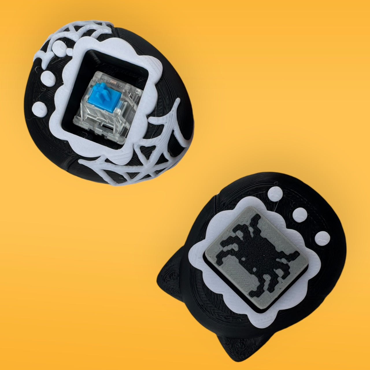 Two black and white decorative items with intricate designs on a yellow background