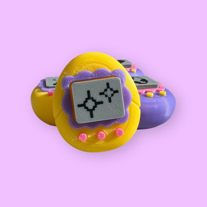 Yellow and purple toy with digital display on a pink background