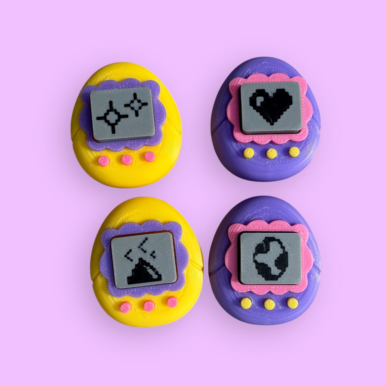 Four colorful buttons with pixelated designs on a pink background